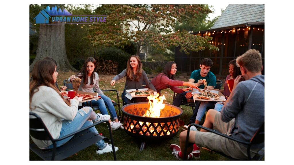 A raised circular fire pit built from stacked natural stone with curved built-in stone bench seating on either side, surrounded by soft landscape lighting and ornamental plantings.